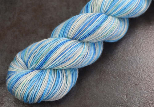 ABOVE THE EDGE: SW Merino / Stellina Sparkle - Hand dyed variegated fingering yarn